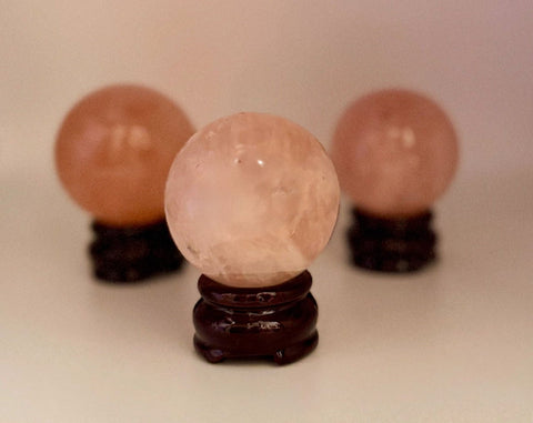 Three Rose Quartz Spheres on wooden stands
