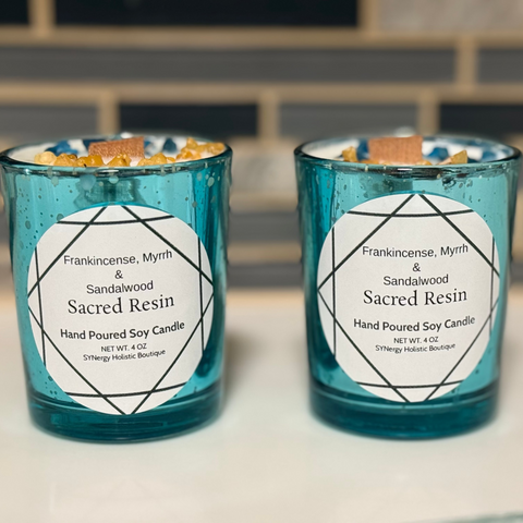 Two blue glass candles with labels on a blurred background