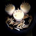 Three small candles with star-shaped wicks on a dark surface