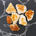 Citrine Clusters on a black marble surface