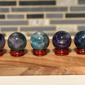 Rainbow Fluorite Sphere with Rosewood Stand – Crystal Healing Decor, Meditation Stone, Third Eye Chakra, Intuition, Energy Clearing Gift - SYN - ergy